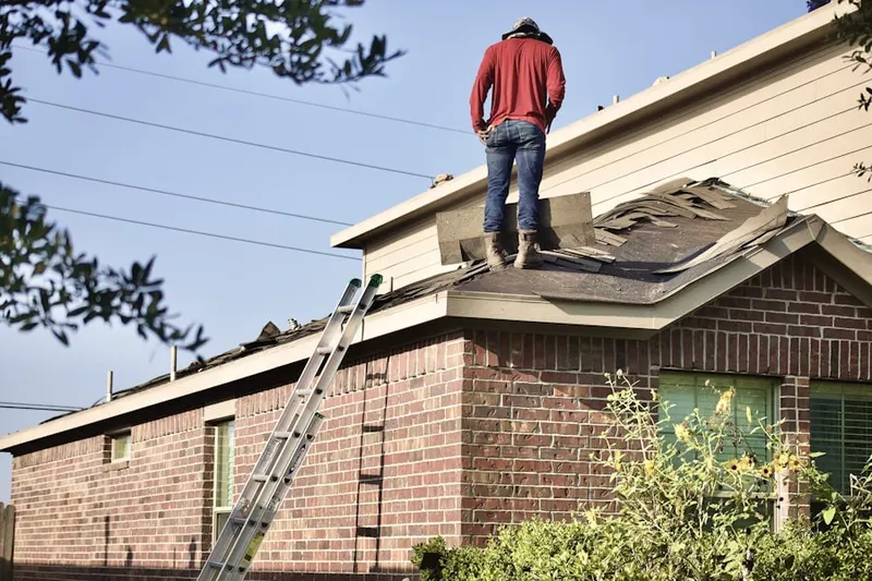 Professional roofer working on a residential roof in Keller